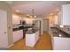 Bright kitchen featuring white cabinets, stainless steel appliances, and an island at 109 Windsong Dr, Stockbridge, GA 30281
