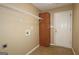 Functional laundry room with storage shelves, cabinet, and utility connections at 109 Windsong Dr, Stockbridge, GA 30281