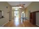 Open-concept living room with hardwood floors, ceiling fan, and great natural light at 109 Windsong Dr, Stockbridge, GA 30281