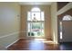Bright room with large windows, hardwood floors, and a decorative chandelier at 109 Windsong Dr, Stockbridge, GA 30281