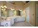 Main bathroom featuring double sink vanity with decorative lighting, mirror and tile floors at 109 Windsong Dr, Stockbridge, GA 30281