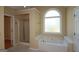 Bathroom area with soaking tub, separate shower and natural light from window at 109 Windsong Dr, Stockbridge, GA 30281