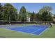 This community features a blue and green tennis court for residents to enjoy the game at 109 Windsong Dr, Stockbridge, GA 30281