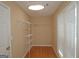 Bright walk-in closet with shelving for storage, hardwood floors, and natural light at 109 Windsong Dr, Stockbridge, GA 30281