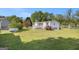 Well-maintained lawn in the backyard, with trees and shrubs, on a bright, sunny day at 73 Highpoint Ln, Locust Grove, GA 30248