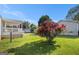 Lush backyard featuring a vibrant rose bush, offering a touch of natural beauty and privacy at 73 Highpoint Ln, Locust Grove, GA 30248