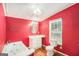 Red bathroom featuring a soaking tub, window, toilet, and sink vanity at 73 Highpoint Ln, Locust Grove, GA 30248