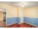 Bedroom featuring hardwood floors, chair rail, ceiling fan and neutral wall colors at 73 Highpoint Ln, Locust Grove, GA 30248