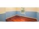 Bedroom with hardwood floors, blue wainscoting, window, and neutral upper wall color at 73 Highpoint Ln, Locust Grove, GA 30248