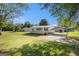 Charming one-story home with covered porch, carport and well-maintained lawn on a sunny day at 73 Highpoint Ln, Locust Grove, GA 30248