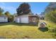 Single-car garage with adjacent carport in a fenced backyard, offering parking and outdoor space at 73 Highpoint Ln, Locust Grove, GA 30248