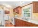 Well-lit kitchen with vintage cabinets, countertops and an adjacent area with appliances at 73 Highpoint Ln, Locust Grove, GA 30248