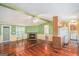 Open-concept living room with hardwood floors, brick fireplace and seamless flow to the kitchen at 73 Highpoint Ln, Locust Grove, GA 30248
