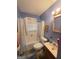 Cozy bathroom with a tiled shower-tub combo, vanity, and coordinated fixtures at 502 S Evelyn Nw Pl, Atlanta, GA 30318