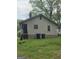 Classic home exterior with neutral siding and stairs, set in a well-maintained yard with mature trees at 502 S Evelyn Nw Pl, Atlanta, GA 30318