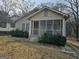 Charming home featuring a screened-in front porch and mature landscaping at 502 S Evelyn Nw Pl, Atlanta, GA 30318