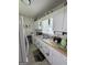 Functional kitchen with white cabinets, double basin sink, and beadboard walls at 502 S Evelyn Nw Pl, Atlanta, GA 30318