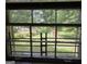 View from the inside looking out of an old pane window with bars, showcasing backyard with shed and garage at 502 S Evelyn Nw Pl, Atlanta, GA 30318