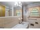 Full bathroom with a vanity, window, and decorative wallpaper at 6520 Rickenbacker Cir, Morrow, GA 30260