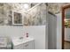 Bathroom with white-tiled walls, a shower, and floral wallpaper at 6520 Rickenbacker Cir, Morrow, GA 30260