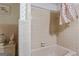 Full bathroom featuring a tile tub and decorative wallpaper at 6520 Rickenbacker Cir, Morrow, GA 30260