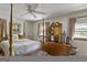 Bright main bedroom with a four-poster bed, large windows, and wood furniture at 6520 Rickenbacker Cir, Morrow, GA 30260