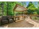 Charming backyard deck featuring an outdoor kitchen with a grill and seating area at 3338 Hackmatack Dr, Kennesaw, GA 30152