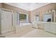 Bright bathroom features a soaking tub with a view, a separate shower, and a double vanity at 3338 Hackmatack Dr, Kennesaw, GA 30152