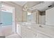 Bathroom boasts a double vanity with white cabinets and a large mirror, offering ample space at 3338 Hackmatack Dr, Kennesaw, GA 30152