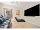 Spacious carpeted bedroom with a large television and comfortable seating arrangement at 3338 Hackmatack Dr, Kennesaw, GA 30152