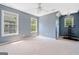 Spacious bedroom with neutral carpet, multiple windows, and a media center at 3338 Hackmatack Dr, Kennesaw, GA 30152