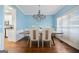 Formal dining room showcasing a modern chandelier and adjacent access to kitchen at 3338 Hackmatack Dr, Kennesaw, GA 30152