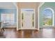 Bright entryway featuring hardwood floors, a decorative window over the door, and an arched window at 3338 Hackmatack Dr, Kennesaw, GA 30152