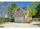 A two-story brick home boasts a two-car garage and well-maintained landscaping in a desirable neighborhood at 3338 Hackmatack Dr, Kennesaw, GA 30152