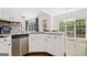 This open kitchen is equipped with stainless appliances and a beautiful view of the backyard at 3338 Hackmatack Dr, Kennesaw, GA 30152