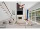 Inviting living room with a fireplace, a two-story window, and a comfortable sectional sofa at 3338 Hackmatack Dr, Kennesaw, GA 30152