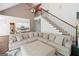 Cozy living room featuring a corner sectional sofa, open staircase and a view into the kitchen at 3338 Hackmatack Dr, Kennesaw, GA 30152