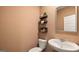 Stylish half bathroom with a pedestal sink and floating shelves at 350 Friendship Oak Way, Hampton, GA 30228