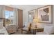 Cozy bedroom with comfortable seating, stylish decor, and natural light from a window at 350 Friendship Oak Way, Hampton, GA 30228