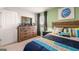 Stylish bedroom with wooden accents, skateboard wall decor, and a dresser at 350 Friendship Oak Way, Hampton, GA 30228