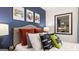 Stylized bedroom with a blue accent wall and gaming themed decor at 350 Friendship Oak Way, Hampton, GA 30228