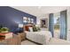 Bedroom features a deep blue accent wall with playful, colorful decor at 350 Friendship Oak Way, Hampton, GA 30228