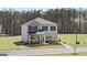 Two-story home with gray siding, black shutters, and a well-manicured lawn at 350 Friendship Oak Way, Hampton, GA 30228