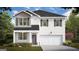 Two-story home featuring white siding, a dark roof, and an attached two-car garage at 350 Friendship Oak Way, Hampton, GA 30228