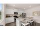 Modern kitchen featuring white cabinets, granite counters, stainless appliances, and breakfast bar at 350 Friendship Oak Way, Hampton, GA 30228