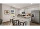 Bright kitchen featuring white cabinets, stainless steel appliances, and a granite island at 350 Friendship Oak Way, Hampton, GA 30228