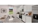 Well-lit kitchen with white cabinetry, granite countertops, and stainless steel appliances at 350 Friendship Oak Way, Hampton, GA 30228