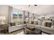 Open-concept living area filled with natural light and comfortable seating at 350 Friendship Oak Way, Hampton, GA 30228