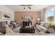 Cozy living room featuring neutral furniture, stylish decor, and abundant light at 350 Friendship Oak Way, Hampton, GA 30228