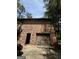 View of the attached garage and side entrance to the home with a brick exterior at 100 Gran De Ct, South Fulton, GA 30349